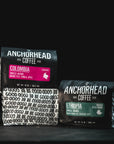 Two Anchorhead Coffee bags, one labeled 'Colombia' and the other 'Ethiopia', on a black background.