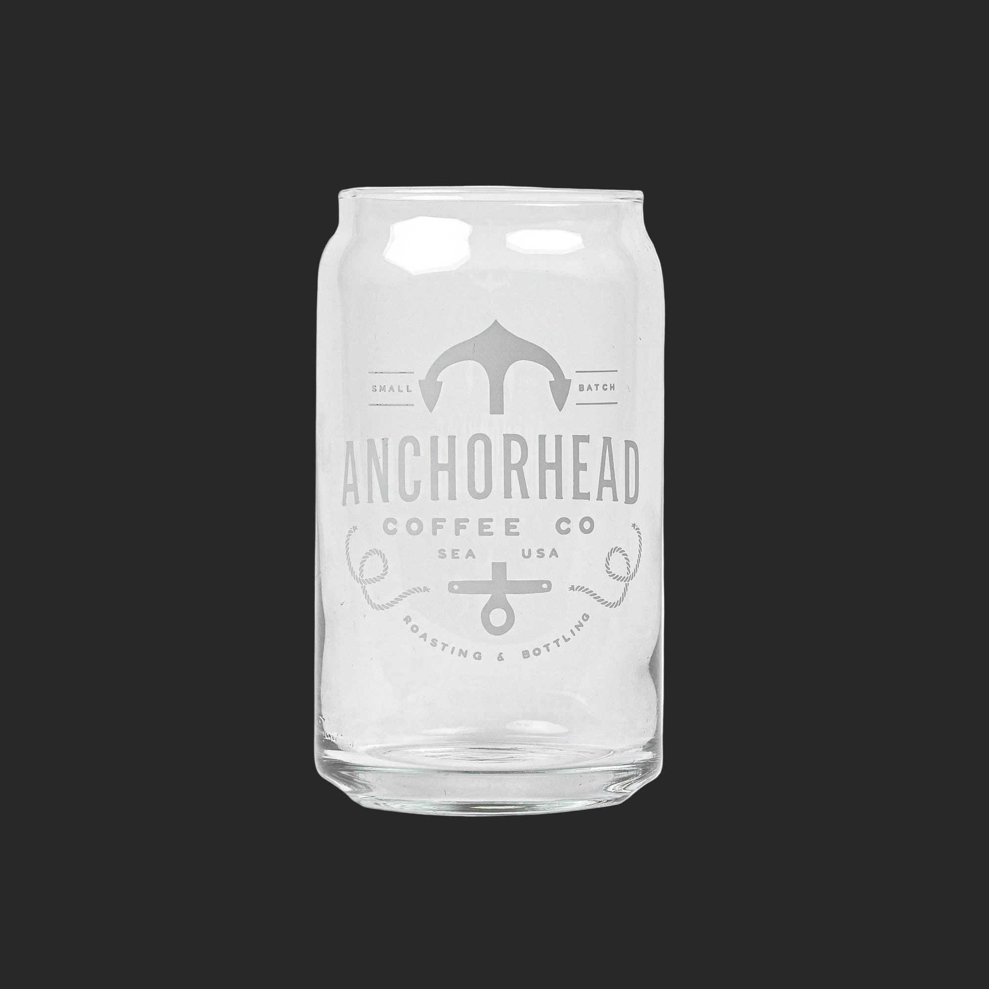Clear glass resembling a soda can with "Anchorhead Coffee Co" and an anchor logo printed in white. Minimalistic design on a dark gray background.